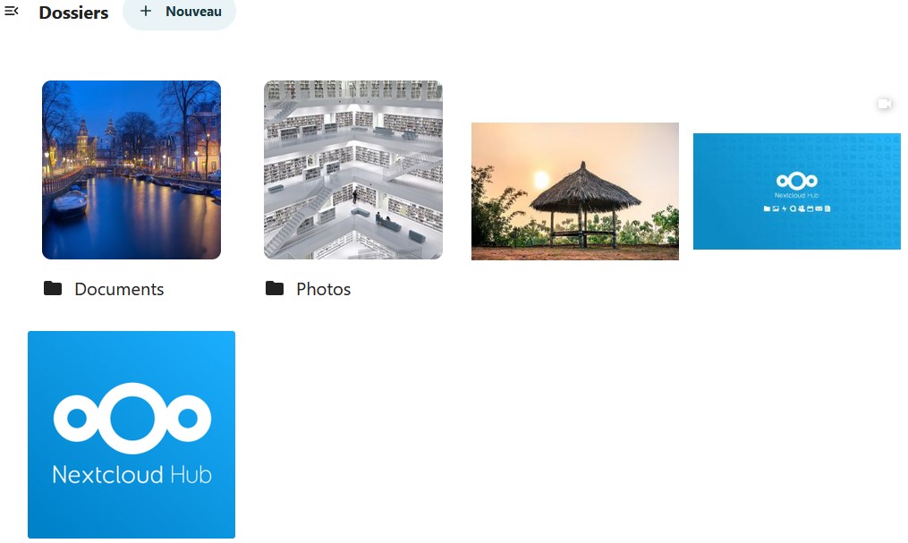 Capture d'écran d'une partie de la page "Dossiers". On voit le titre en haut "Dossiers", à sa droite le bouton "+ Nouveau". Dessous 2 dossiers "Documents" et "Photos" chacun aillant comme vignette l'une des photos présente dans ces dossiers. A côté il y a une image, la vignette dune vidéo et à la ligne en-dessous une autre image.