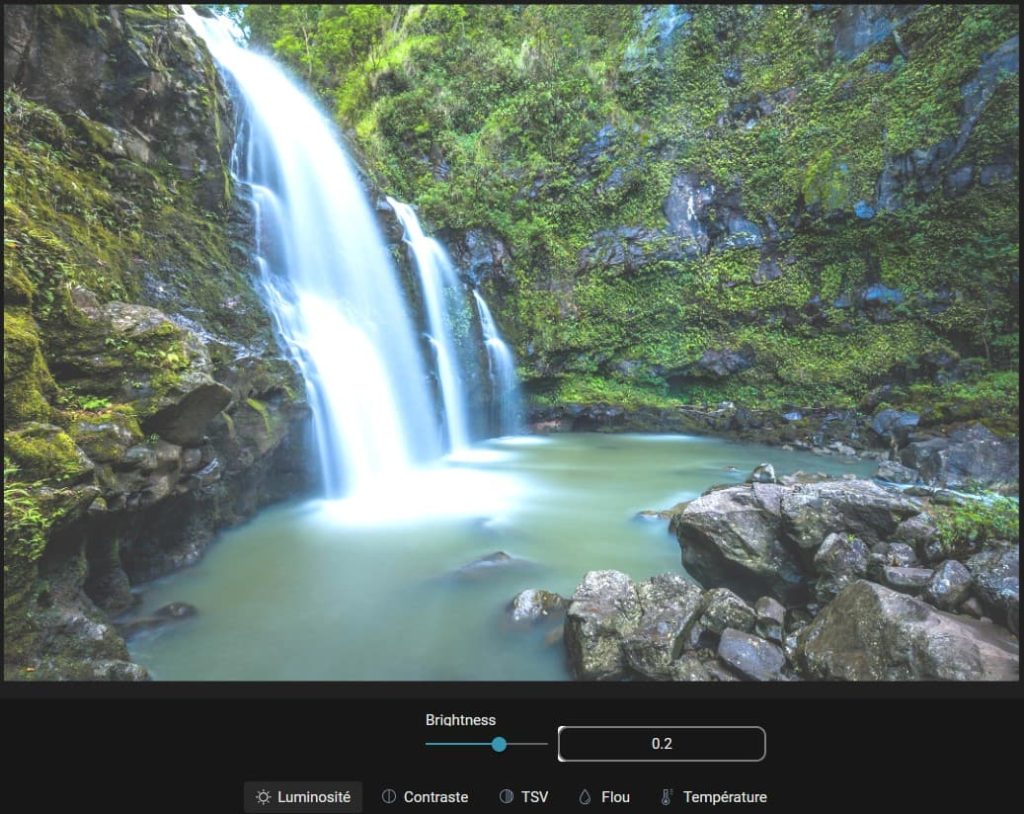 Capture d'écran d'une image (une cascade) ouverte dans la partie "Réglages fins", "Luminosité" des modifications. dans la partie basse le paramètre pour la luminosité est un petit rond à tirer vers la droite ou la gauche pour modifier le contraste. Sur la droite de cette réglette, un champ avec un chiffre indiquant le taux de luminosité. En-dessous il y a 5 items, "Luminosité", "Contraste", "TSV", "Flou" et "Température".